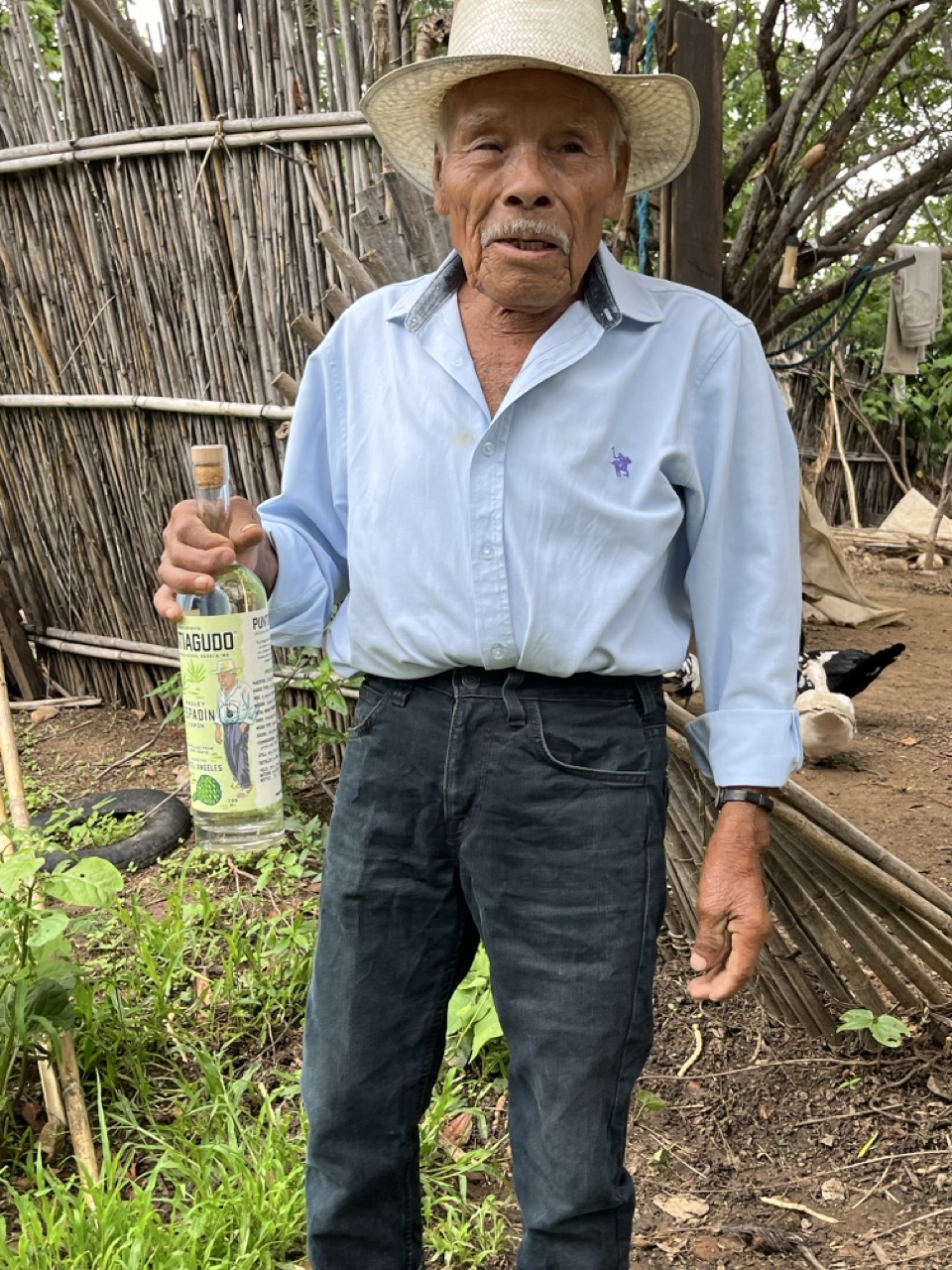 ANGEL HOLDING HIS PUNTIAGUDO BOTTLE de tamaño grande